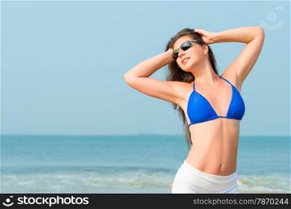 Slim pretty girl in sunglasses enjoying the sun