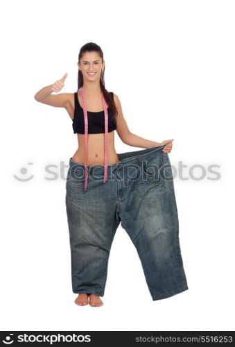 Slim pretty girl with a big trousers saying Ok isolated on a white background