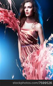 slim sexy woman in pink dress with long hair and paint splash