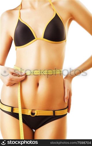 slim woman body in swimsuit with measure on white background
