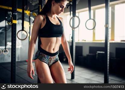 Slim woman on fitness workout in club. Female athlete training in sport gym