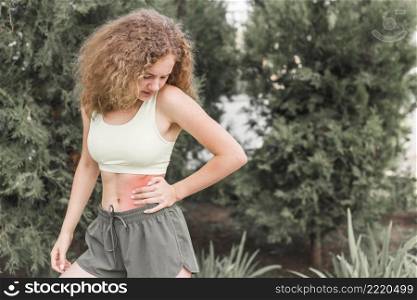 slim young woman looking waist injury