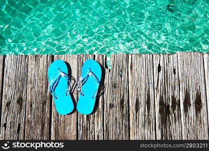 Slippers at jetty by the sea