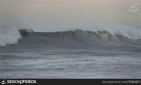 Slo-motion cresting waves tumble by