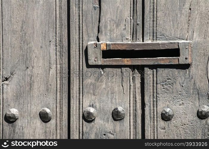 Slot in mailbox on old vintage wooden door