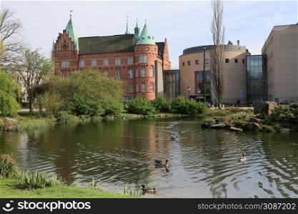 Slottsparken park pond and city library buildings, Malmo, Sweden8