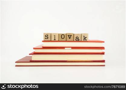 slovak word on wood stamps stack on books, language and academic concept