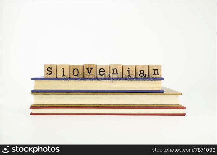 slovenian word on wood stamps stack on books, language and conversation concept