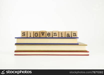 slovenian word on wood stamps stack on books, language and conversation concept