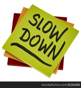 slow down reminder or advice - handwriting on an isolated sticky note, reducing stress concept