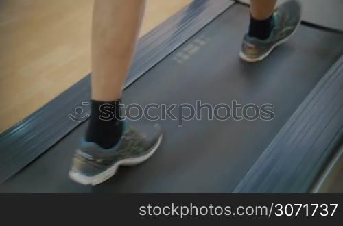 Slow motion close-up shot of feet exercising on stepmill. Keeping fit with regular sports