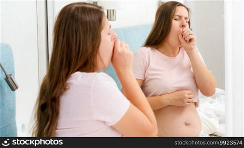 Slow motion of young pregnant woman feeling sick and coughing in hand. Slow motion of young pregnant woman feeling sick and coughing in hand.