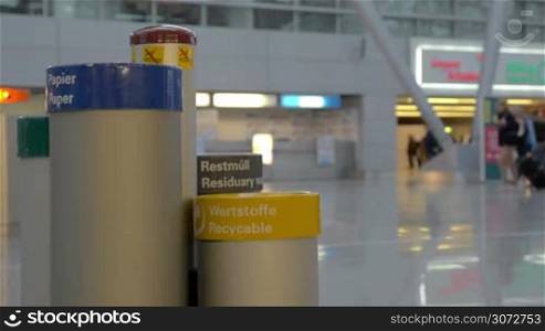 Slow motion shot of containers of separate waste collection standing in the airport.