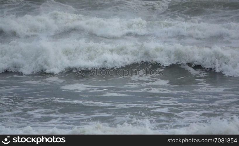 Slow motion waves cascade on beach