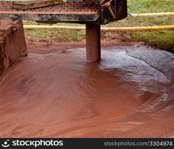 Slurry of mud from drilling for geothermal power system in suburban yard