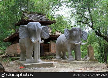 Smal chinese emple with elephants in the forest