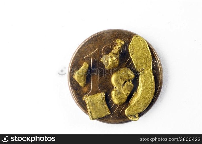 small alluvial gold nuggets found in France and placed on a one euro coin cent
