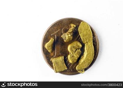 small alluvial gold nuggets found in France and placed on a one euro coin cent