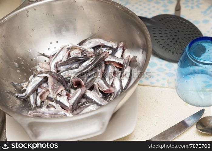 small anchovies cleaning the guts to eat