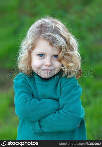 Small angry kid with green jersey in the field