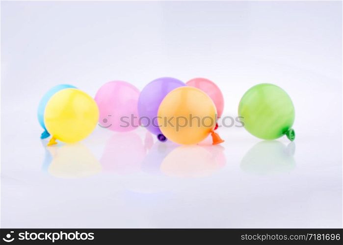 small balloons of various color on a white background