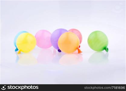 small balloons of various color on a white background