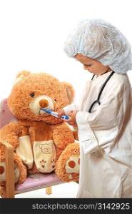 small beautiful girl playing doctor and healing taddy bear