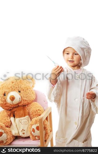 small beautiful girl playing doctor and healing taddy bear