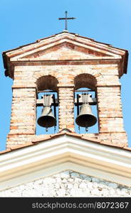 Small bell tower with a bell of a country church in the 14th century