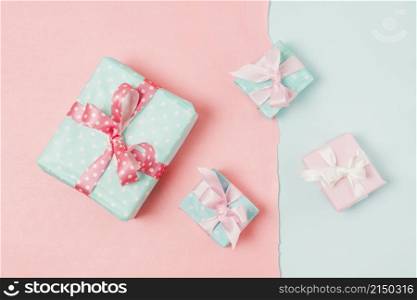 small big decorated gift boxed tied with ribbon arrange peach blue wallpaper