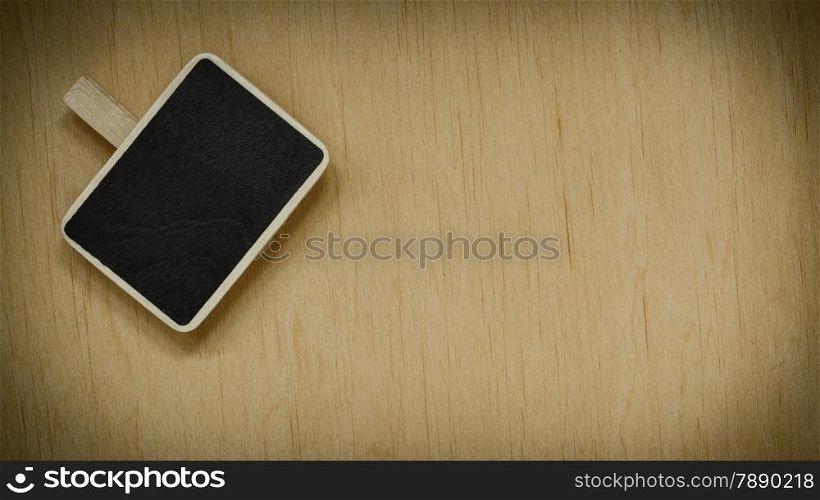 small blackboard slate chalk board clip with space for text menu on wooden surface, empty blank sign