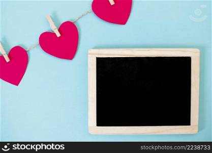 small blackboard with garland hearts