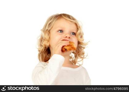Small blond child eating a croissant isolated on a white background