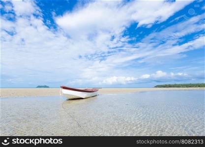 small boat on the beach. boat moored on the sand by the sea.