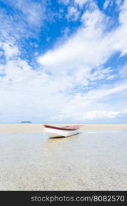 small boat on the beach. boat moored on the sand by the sea.