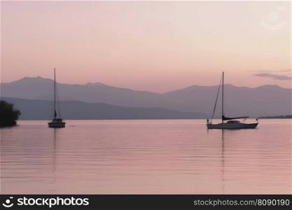 Small boats and yachts in the bay of the sea at sunset. Neural network AI generated art. Small boats and yachts in the bay of the sea at sunset. Neural network AI generated