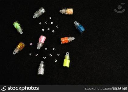 Small bottles filled with nail decorations