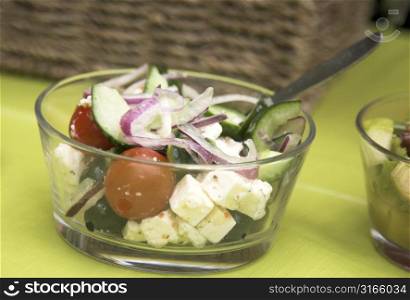 Small bowl of greek salad in the garden