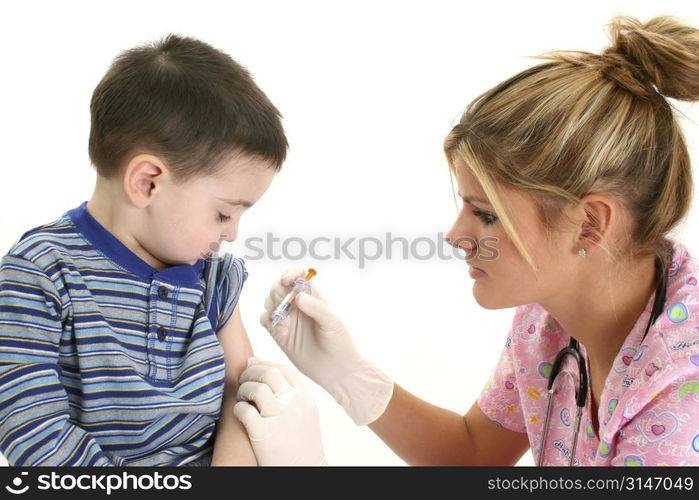 Small boy watching as nurse gives him a shot.