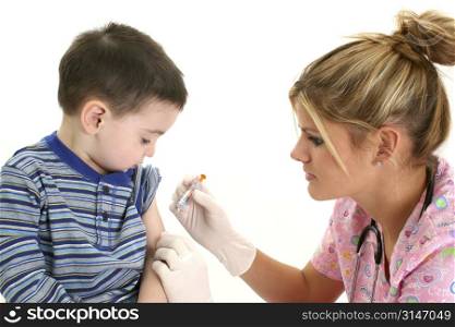 Small boy watching as nurse gives him a shot.