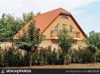 Small brick house with red tiled roof in Odessa, Ukraine