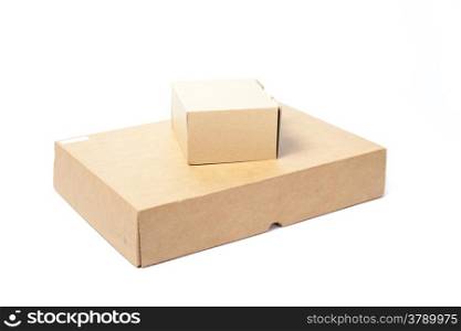 Small brown paper box on a large box.on white isolated background in studio.