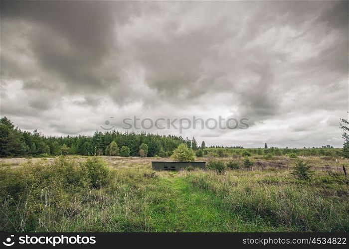 Small bunker in a military terrain in cloudy weather