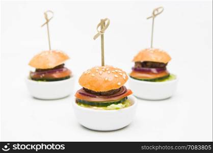 small burgers with beef and vegetables. various snacks.