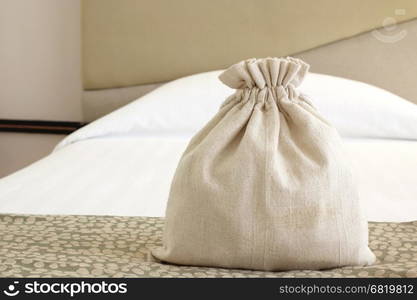 small burlap fabric pouch on the bed