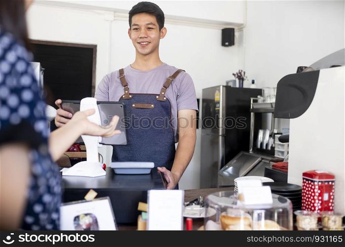 Small Business and Owner Business Concept. Young owner of coffee cafe service customer.
