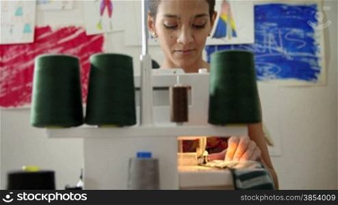 Small business and self-employed women, young hispanic woman working as fashion designer with sewing machine in studio. Sequence