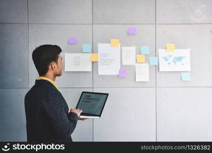 Small Business and Strategy Concept. Young Businessman in Office Meeting Room. Working with Computer Laptop and Document to Analyzing Plans and Project