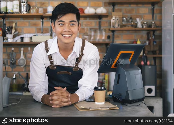 Small business happy owner of a coffee cafe. Young startup owner small cafe shop.