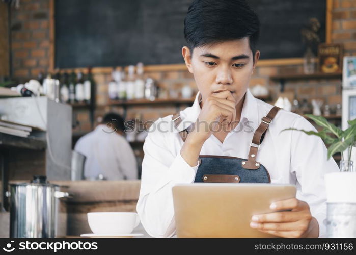 Small business owner of a cafe. Young startup owner small cafe shop.